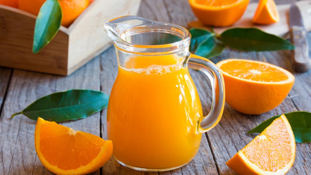 naranjas-siendo-exprimidas-manualmente
